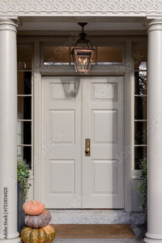 In the picturesque setting of New England, pristine white double doors stand as elegant gateways, embodying the timeless grace and refined simplicity. 