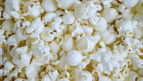 Fresh popcorn snacks in a wooden bowl spinning.