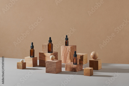 Glass cosmetic dropper bottle and cream jar mockup on wooden cubes photo