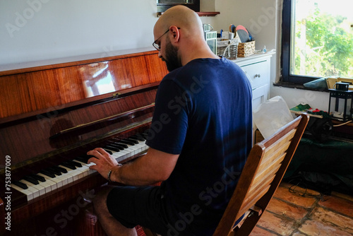 Man Enjoying Playing The Piano At Her Home photo