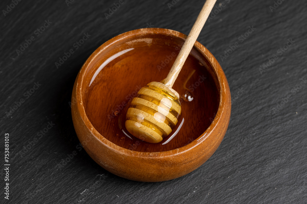 natural bee honey in a round wooden plate natural bee honey in a round wooden plate