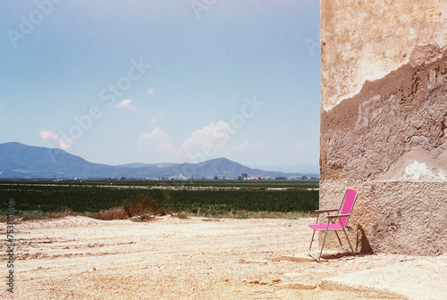 lonely beach chair on a rural landscape, 35mm film photo