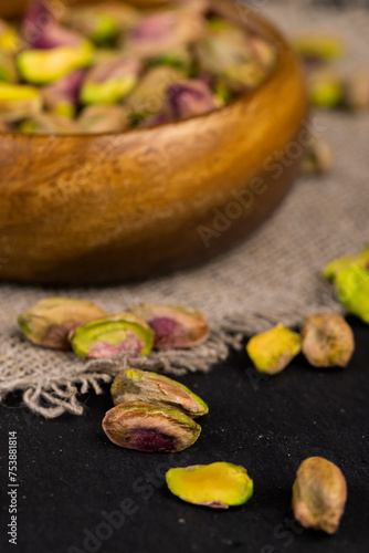 peeled pistachios in a wooden bowl, close-up © rsooll