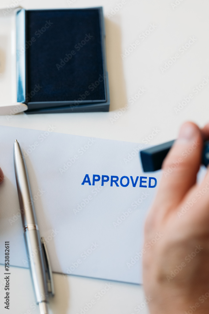 © Studio Firma/Stocksy - Man Signing Approved Document © Studio Firma/Stocksy - Man Signing Approved Document