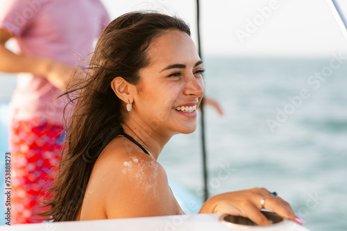 Joyful Woman with Wind-Blown Hair on Boat photo