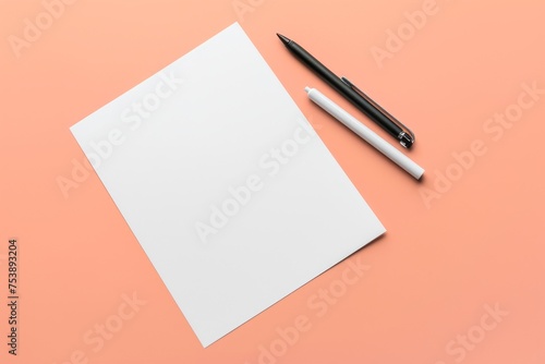 A blank Us letter paper and markers on peach background. Resume or cover letter mockup. Blank paper for stationery design.