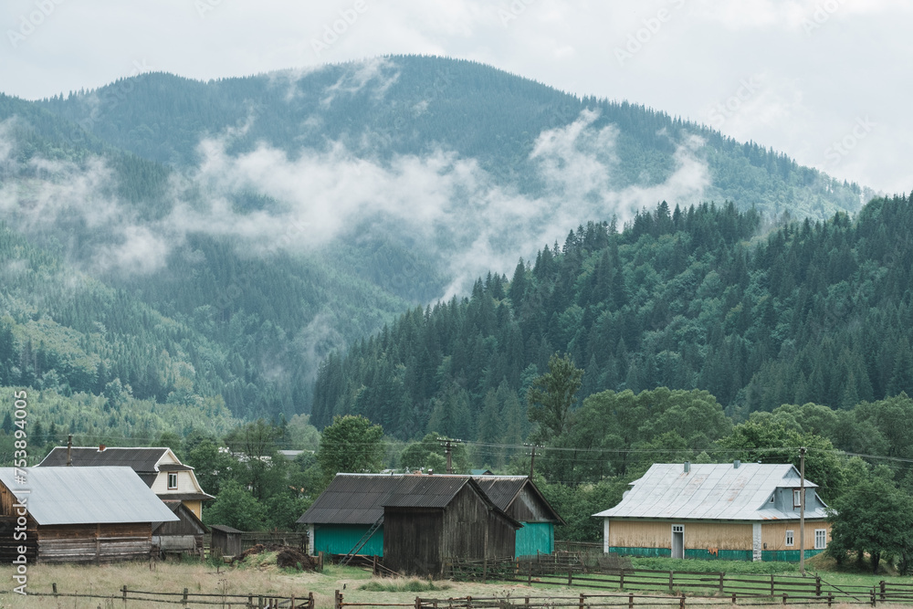 Cloudy mountain village after the rain. Fog on the mountain after the rain