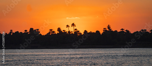 silhouette of the Nile river shoreline at sunset
