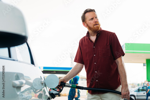 Man Refilling Car Tank with Petrol  photo