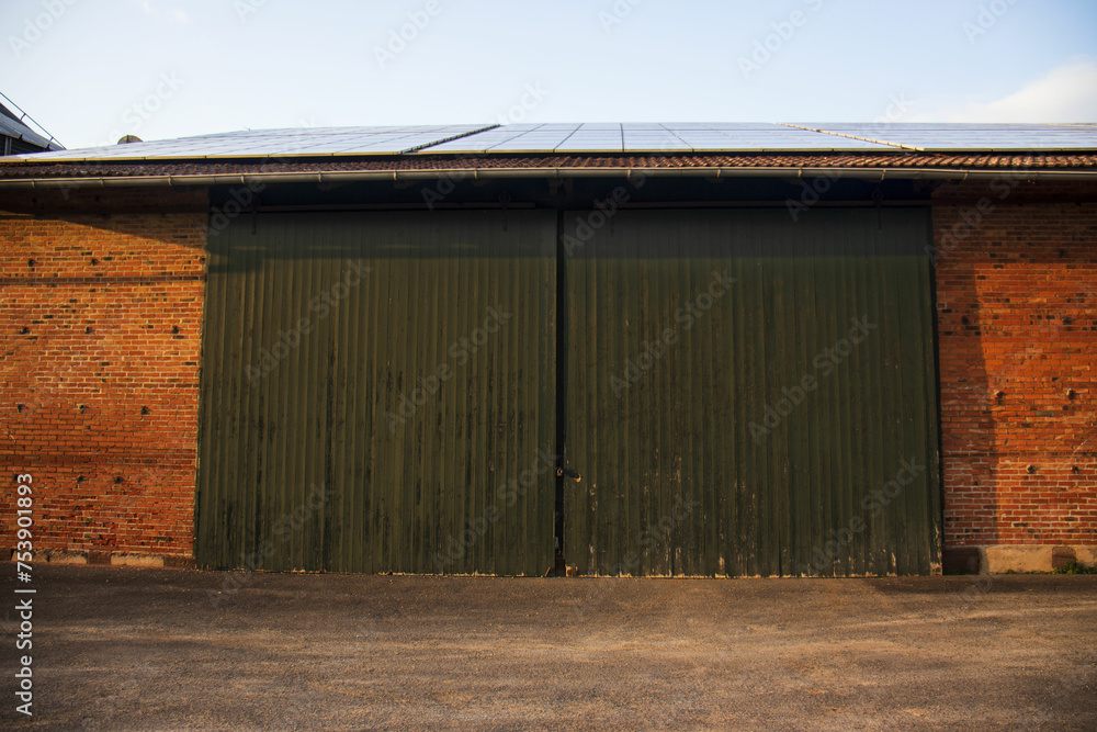 Large gates of warehouse doors , garage for tarctor on the farm Large gates of warehouse doors , garage for tarctor on the farm