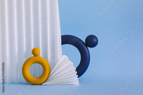 Two colored objects together on paper background