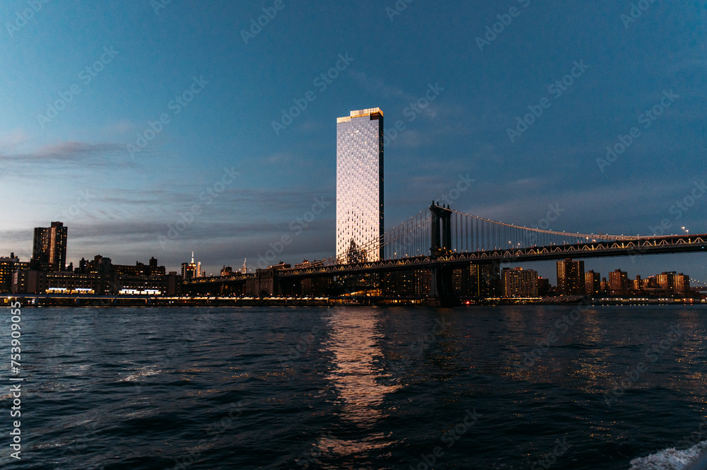 Skyscraper located near Manhattan Bridge in evening Skyscraper located near Manhattan Bridge in evening