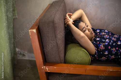 Teenage Indian girl relaxing and taking rest inside a house photo