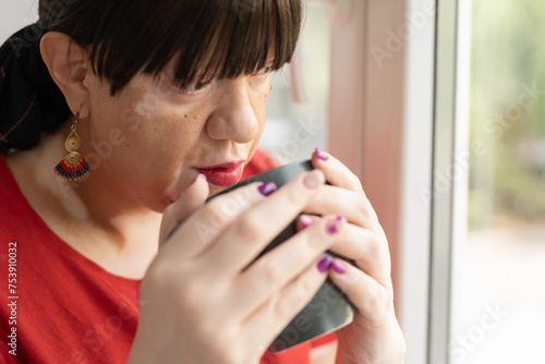 Woman with autoimmune disease drinking tea