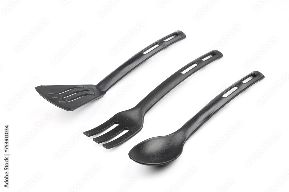 Black plastic kitchen spatula and spoon isolated on white background Black plastic kitchen spatula and spoon isolated on white background
