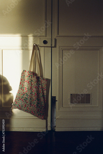 A door with a shopping bag hanging on the handle photo