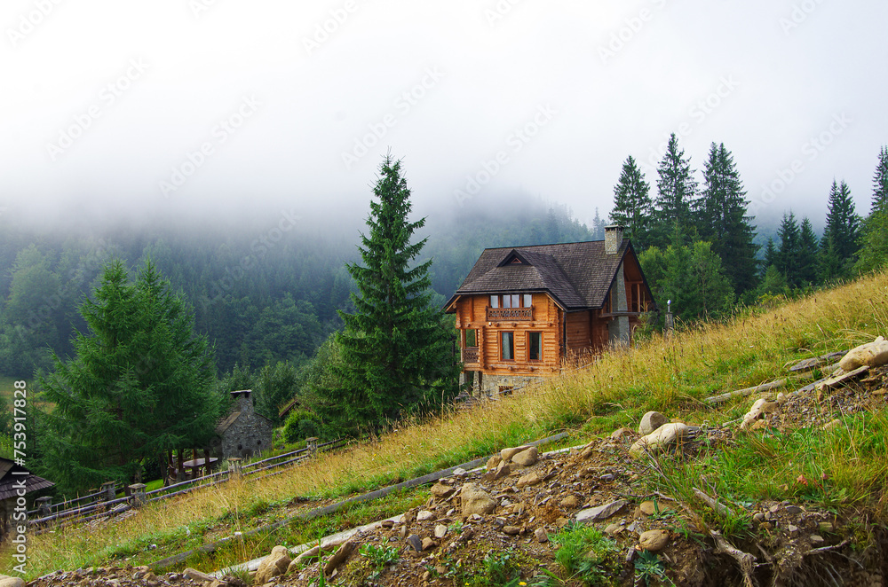 beautiful wooden house in the mountains on the background of forest and fog beautiful wooden house in the mountains on the background of forest and fog
