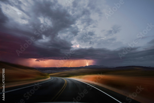 Desert Drive: 4K Ultra HD Image of Driving on a Desert Road with Thunderstorm Ahead © Only 4K Ultra HD