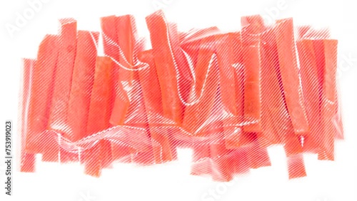 Packaging and Freezing Carrots. Carrot sticks are vacuum packed and quickly cooled with an ice jet, creating the effect of white steam on a white background photo