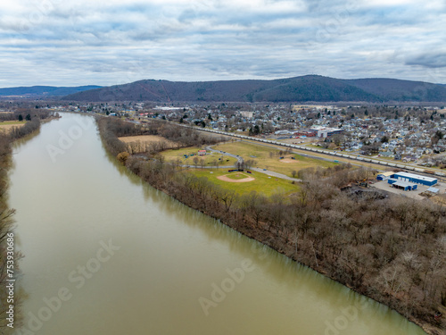Sayre, PA, USA - 03-03-2024 - Cloudy winter aerial image of Chemung River near downtown area in the City of Sayre, PA. 