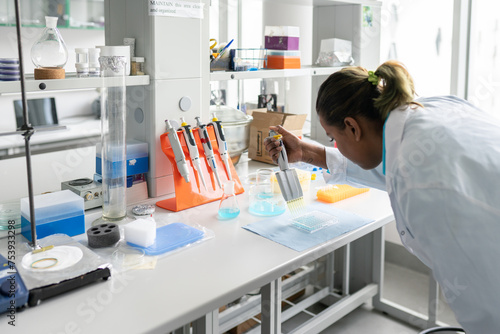 Indian Scientist Holding Pipette In The Lab photo
