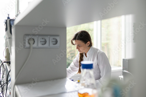 Female Researcher Working In Birght Modern Lab photo