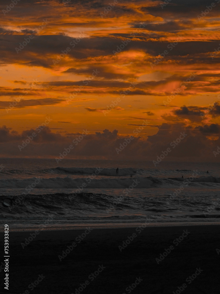 Fototapeta premium Magic orange sunset view. A sunset is a natural phenomenon that occurs daily as the sun dips below the horizon, marking the end of daylight hours. It is a breathtaking and often picturesque event 