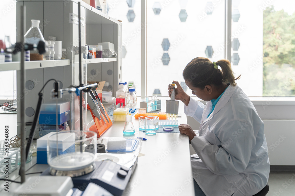 Indian Scientist Using Pipette In Lab Indian Scientist Using Pipette In Lab