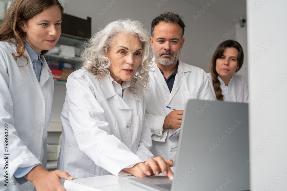 Group Of Researchers Using Computer In Lab Group Of Researchers Using Computer In Lab