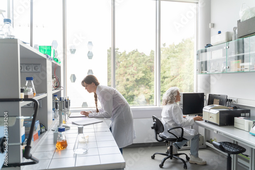 People Working In Modern Bright Laboratory photo