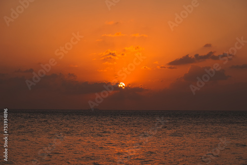 Magic orange sunset view.
A sunset is a natural phenomenon that occurs daily as the sun dips below the horizon, marking the end of daylight hours. It is a breathtaking and often picturesque event 