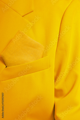 Close-up of a person wearing yellow blazer and tissue in a pocket photo