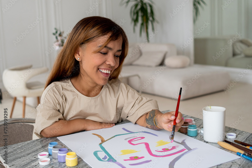 Attractive dwarf woman painting a portrait Attractive dwarf woman painting a portrait