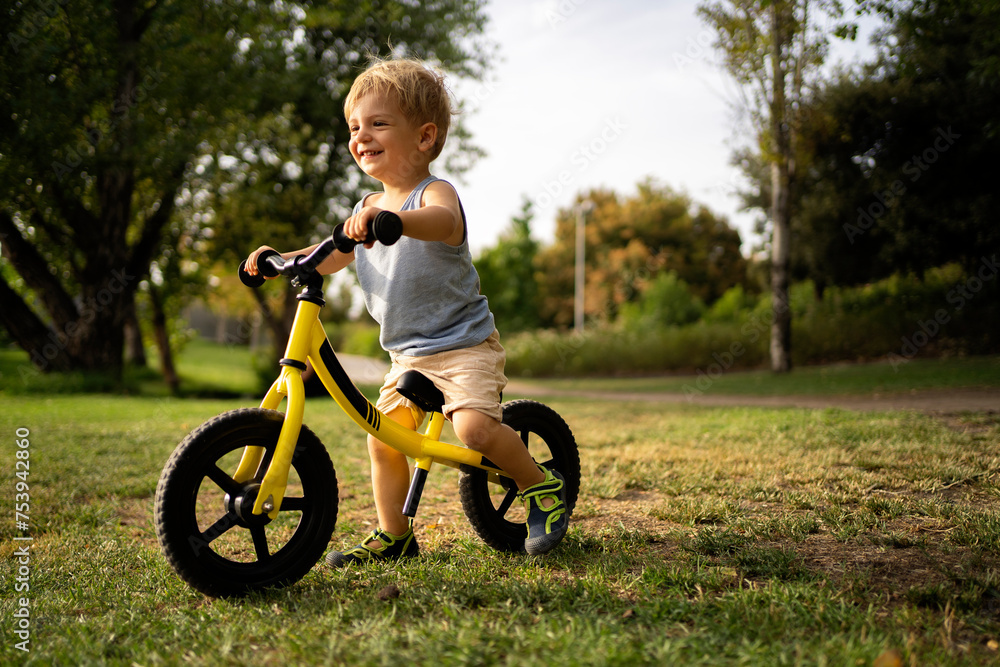 Little boy riding bicycle in park Little boy riding bicycle in park