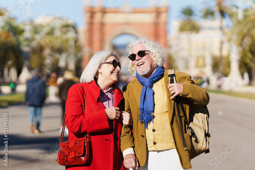 Photography Senior tourist couple laughing outdoors while visiting city.