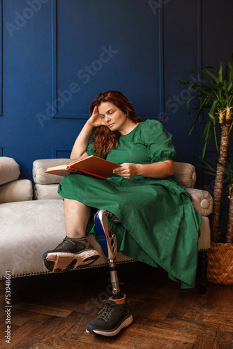 A focused disabled woman with a prosthesis is engaged in her hobby