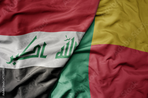 big waving national colorful flag of benin and national flag of iraq.