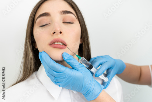 Woman getting cosmetic injection of botox near lips  closeup. Woman in beauty salon. plastic surgery clinic
