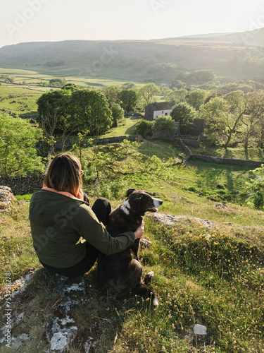 Walker and dog resting at sunset in North Yorkshire. photo