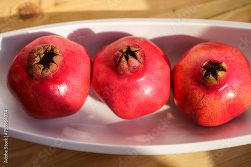 Ripe Pomegranates. Sunlit Still Life. photo