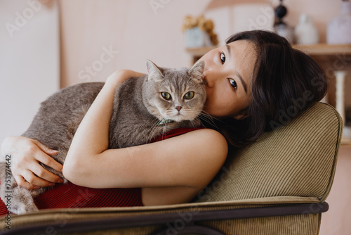 Beautiful young Asian woman with a fluffy cat  photo