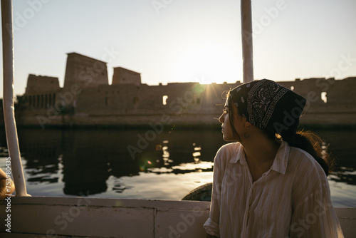 Woman sailing on the Nile River in a boat at Philae, Egypt photo