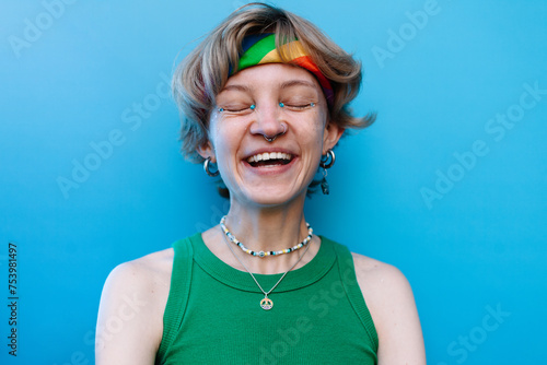 Cheerful queer woman with glitter makeup on face photo