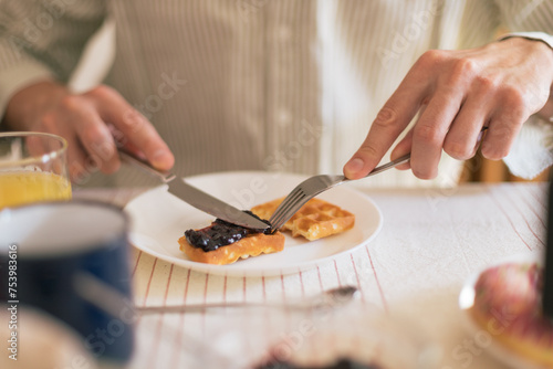 Detail of a man cutting the waffle photo