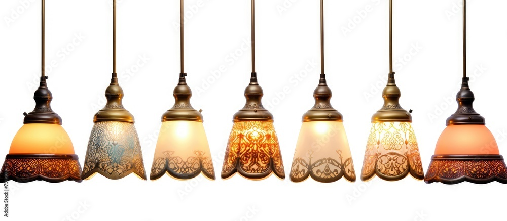 Obraz premium A collection of decorative vintage ceiling lamps hangs from the ceiling, creating an elegant and nostalgic ambiance. The intricate design and warm glow of the lights add character to the room.