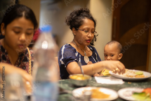 Family having dinner in a restaurant photo