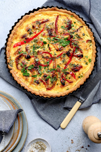 Gourmet chicken quiche with capsicum captured in an overhead portrait shot on a light table setting. photo