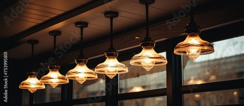 A collection of classic ceiling lights hanging from the ceiling of a coffee cafe, creating a warm and inviting atmosphere.