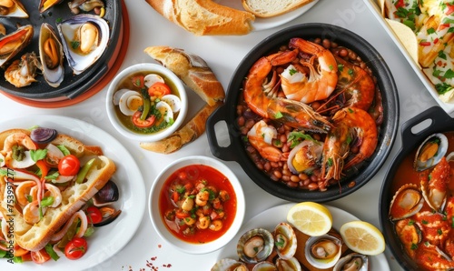 Spanish Mediterranean cuisine. View to table with different seafood dishes, tapas and fresh bread