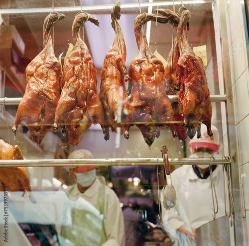Peking ducks in window